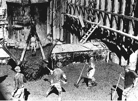 Photo. Puddlers compacting concrete.